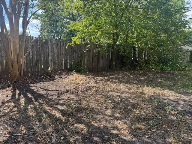 a view of outdoor space with wooden fence