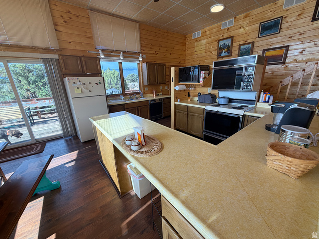 358 South Sky Drive Torrey, UT 84775 - Photo 18 of 82 Kitchen featuring wood-finish flooring, wood plank walls, and light-toned countertops