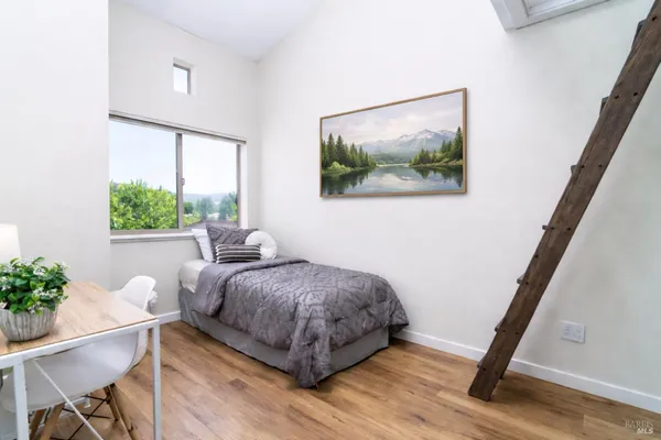 a bedroom with a bed and a potted plant