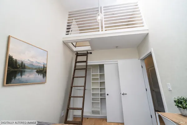 a view of a hallway with wooden floor and entryway