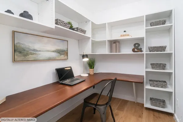 a bedroom with a bed and a bookshelf with wooden floor