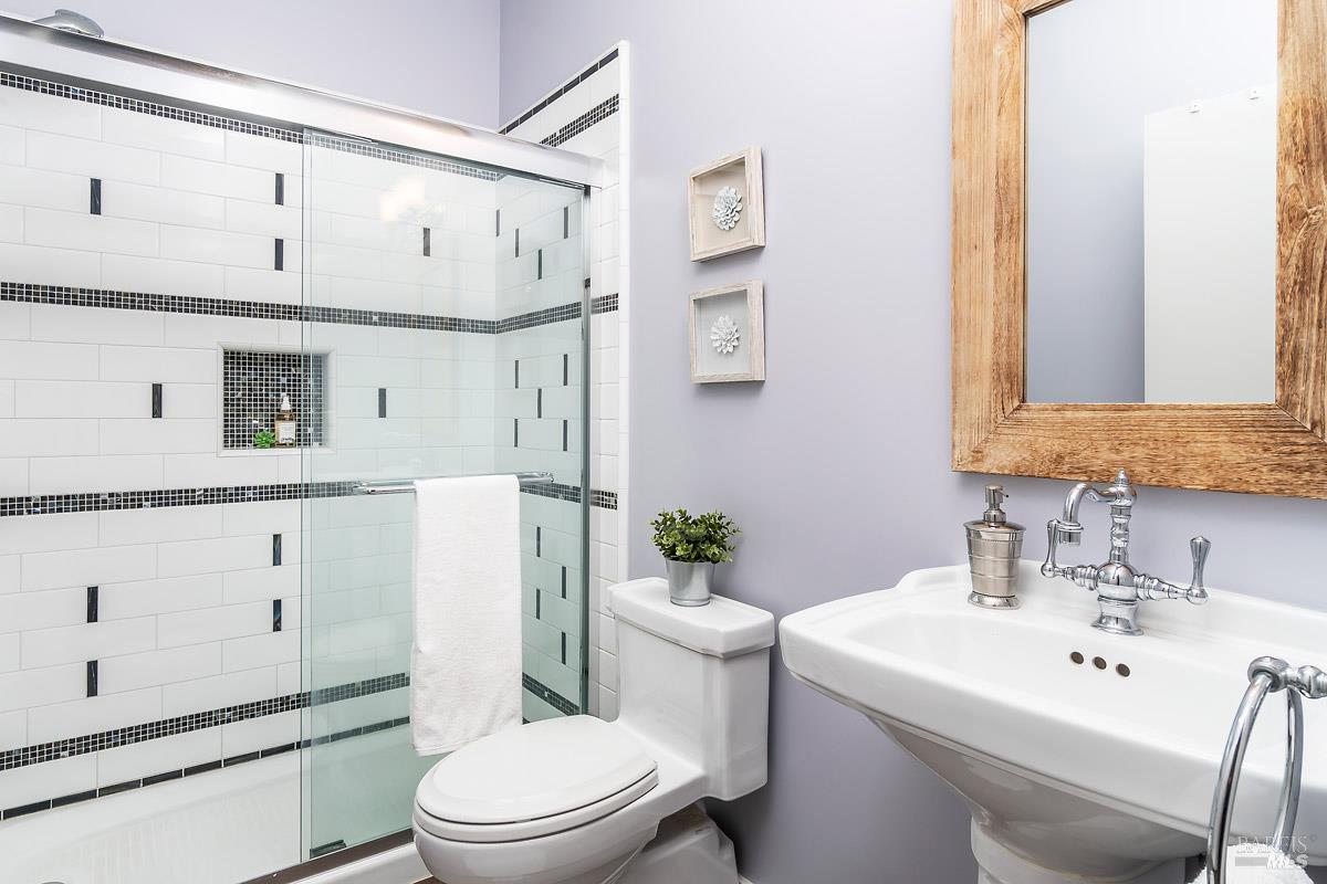 1354 Yulupa Avenue, Unit E Santa Rosa, CA 95405 - Photo 16 of 24 a bathroom with a sink a toilet and shower
