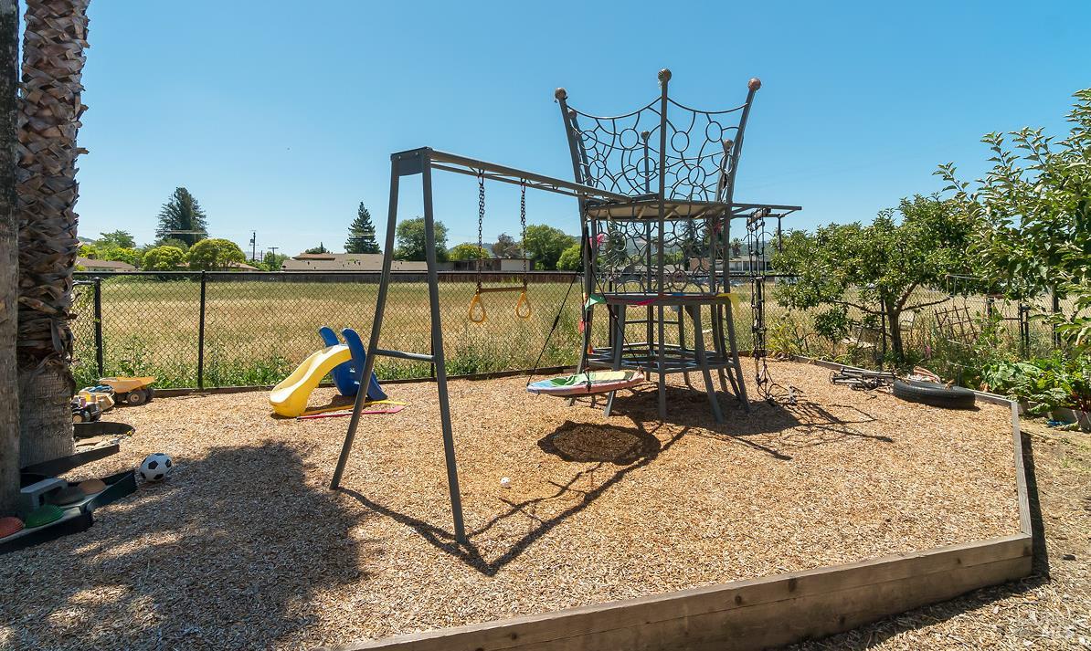 1354 Yulupa Avenue, Unit E Santa Rosa, CA 95405 - Photo 20 of 24 a view of a lake with a table and chairs