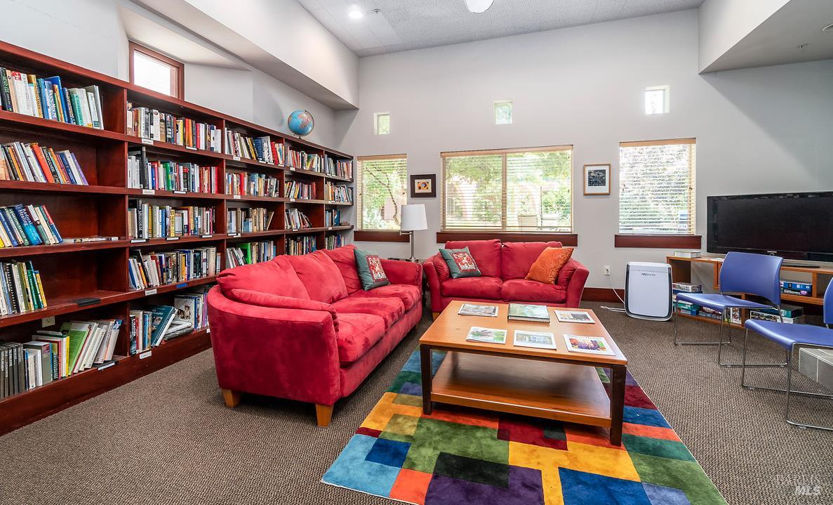 1354 Yulupa Avenue, Unit E Santa Rosa, CA 95405 - Photo 22 of 24 a living room with furniture and a book shelf