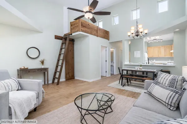 a living room with furniture a chandelier and a window