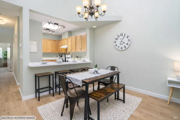a view of a dining room with furniture and chandelier