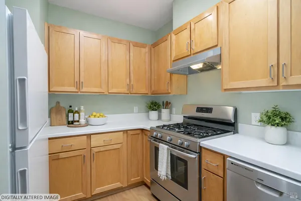 a kitchen with stainless steel appliances granite countertop a stove a sink and cabinets