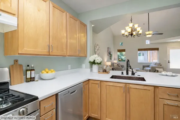 a kitchen with a sink dishwasher and white cabinets