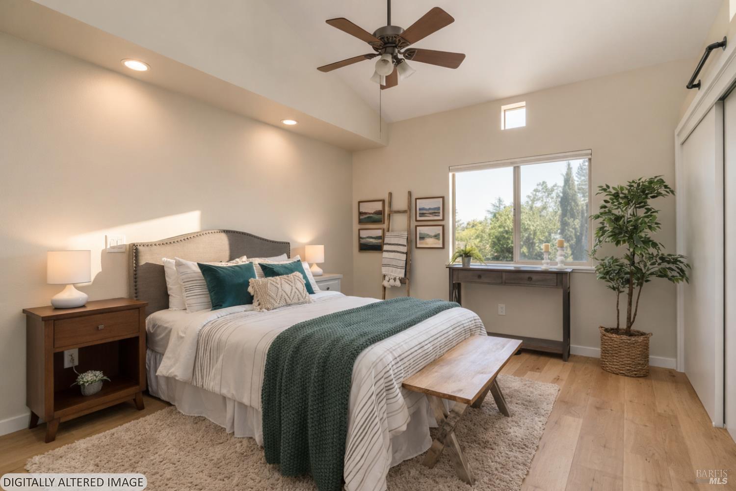 1354 Yulupa Avenue, Unit E Santa Rosa, CA 95405 - Photo 10 of 24 a bedroom with a large bed and a potted plant