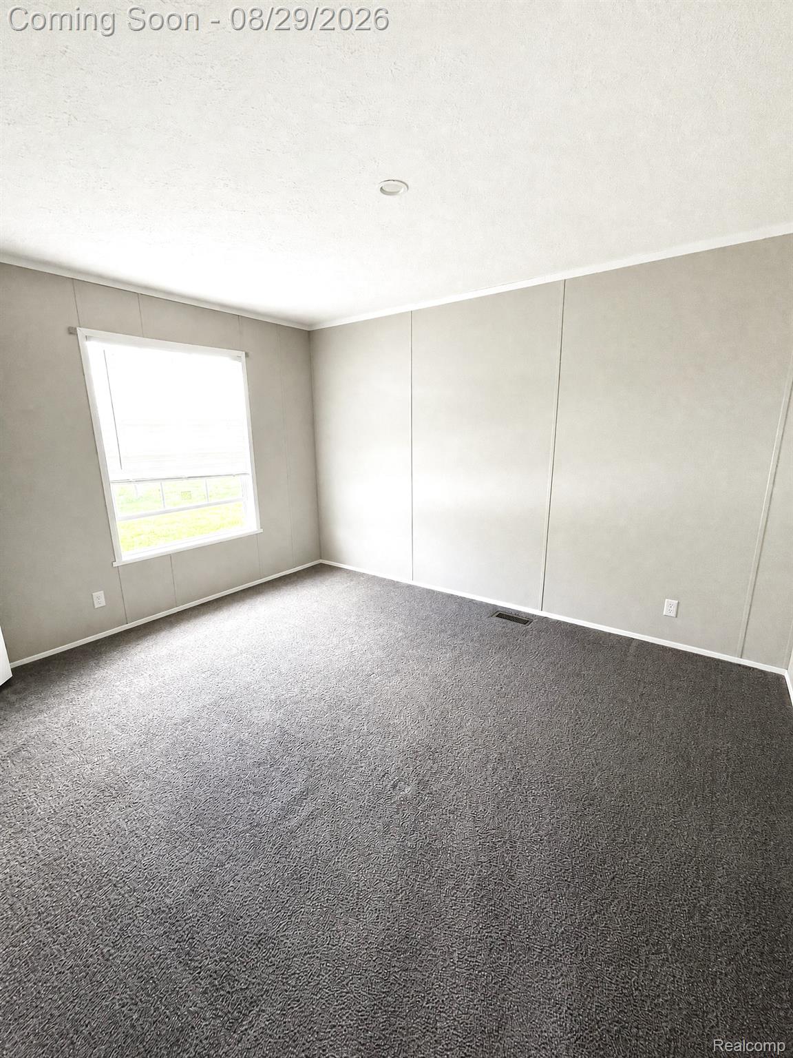46000 Geddes Road, Unit 520 Canton, MI 48188 - Photo 20 of 29 Spacious room featuring neutral wall paneling, recessed lighting, white trim, and dark gray carpeting