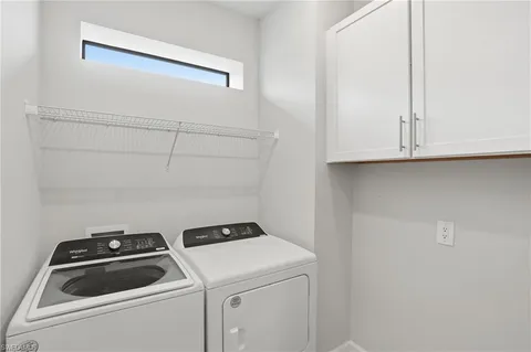 a view of storage and utility room with washer and dryer