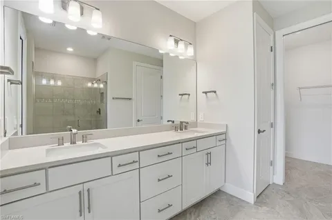 a bathroom with a double vanity sink and a mirror
