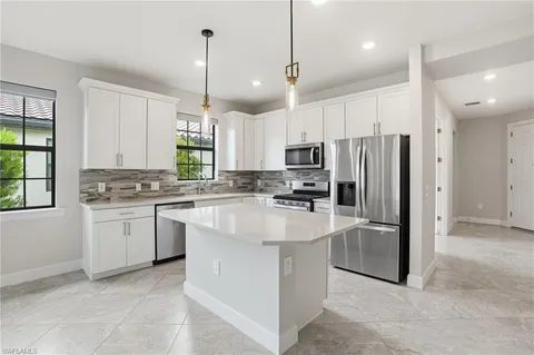 a kitchen with refrigerator and window