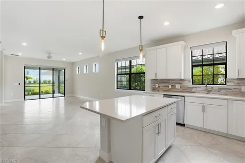 a kitchen with a sink cabinets and window