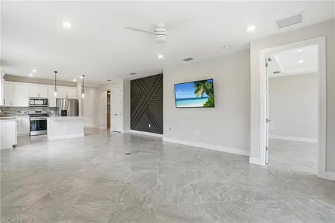 a view of a kitchen with refrigerator and cabinets