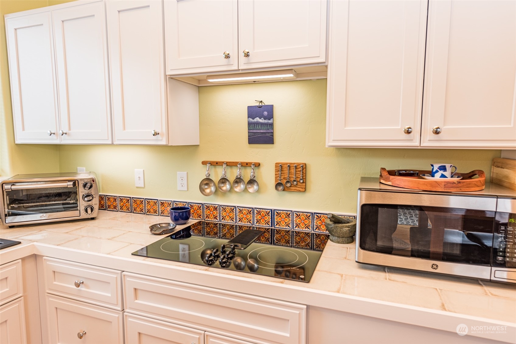 400 Ridge View Drive Sequim, WA 98382 - Photo 15 of 40 a kitchen with a stove and white cabinets
