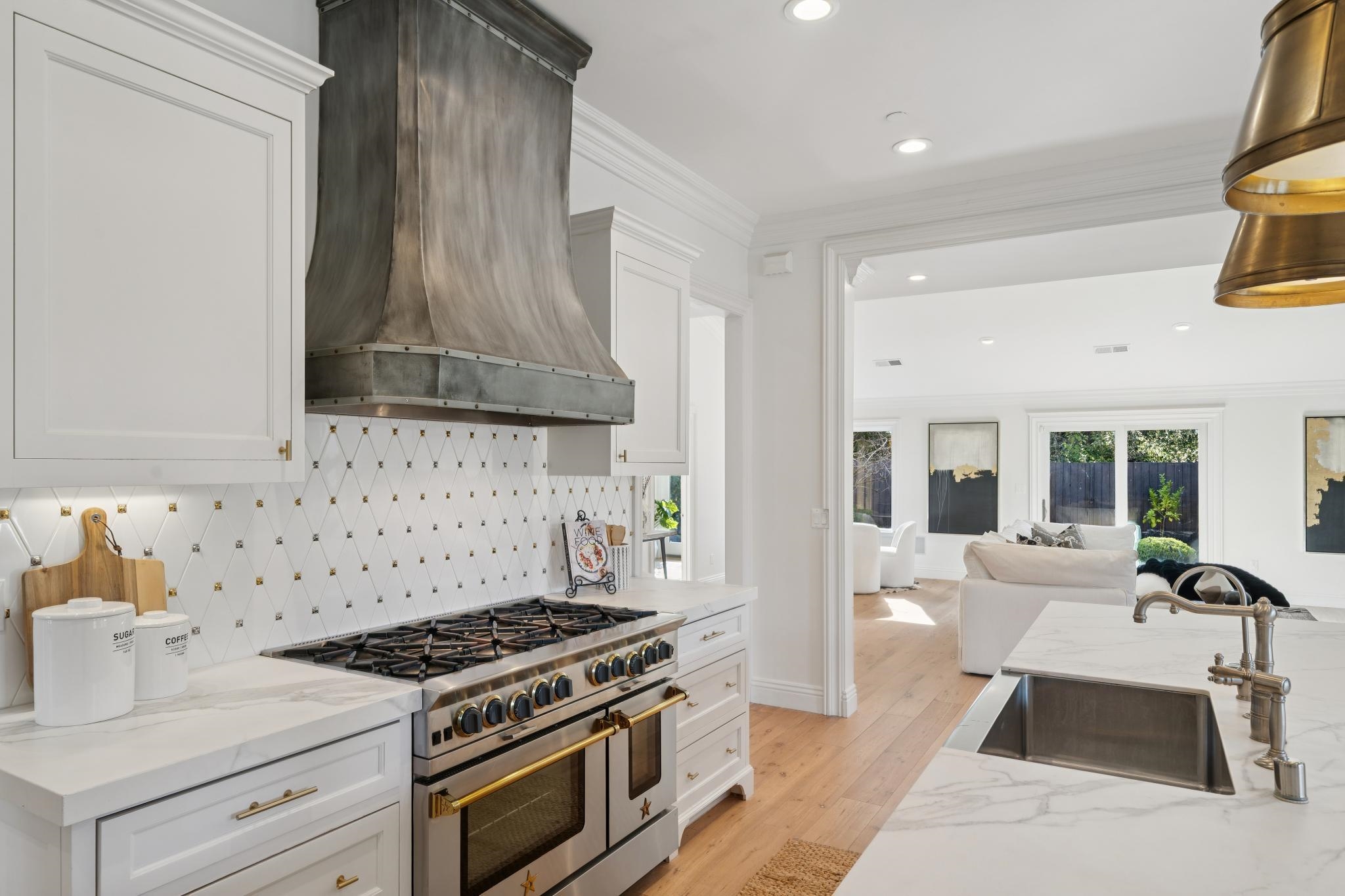 3957 Rancho Road Lafayette, CA 94549 - Photo 17 of 60 Kitchen featuring range with two ovens, light stone counters, custom range hood, white cabinetry, and recessed lighting