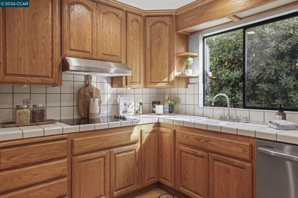 3613-3613 Longview Road Antioch, CA 94509 - Photo 12 of 30 a kitchen with stainless steel appliances wooden cabinets a sink and a window