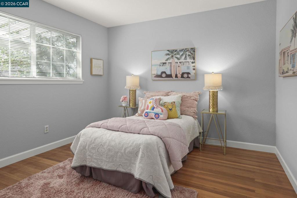 3613-3613 Longview Road Antioch, CA 94509 - Photo 13 of 30 a bedroom with a bed and wooden floor