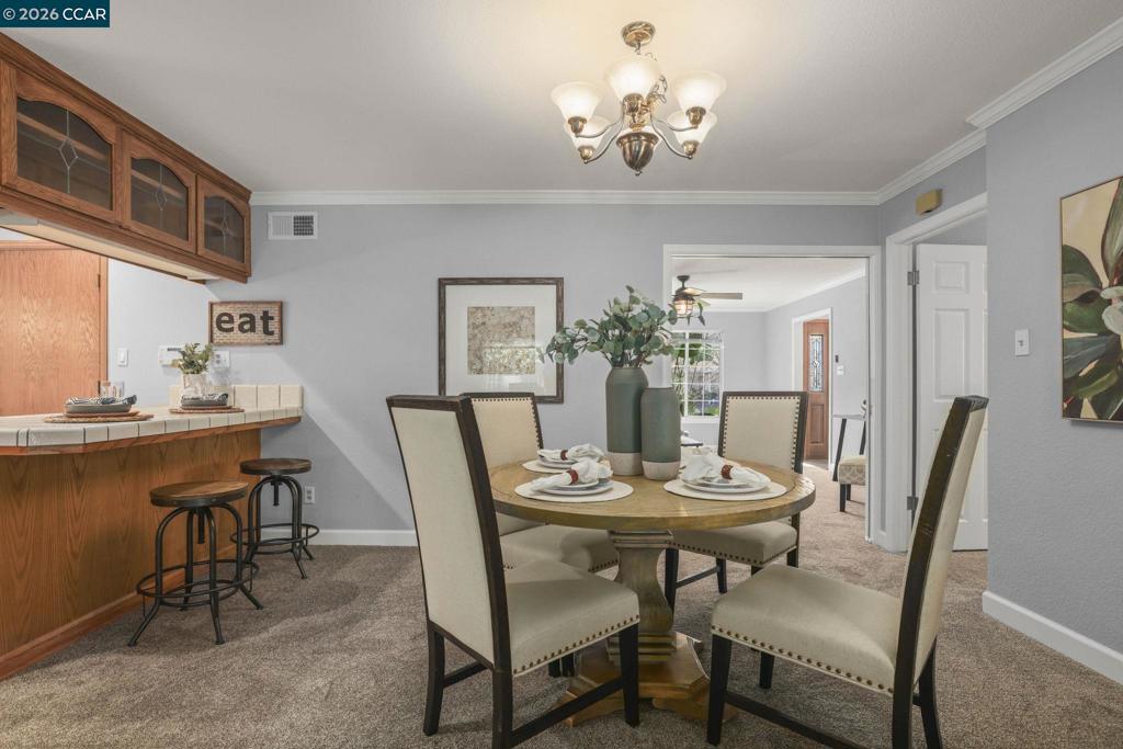3613-3613 Longview Road Antioch, CA 94509 - Photo 15 of 30 a view of a dining room with furniture and chandelier