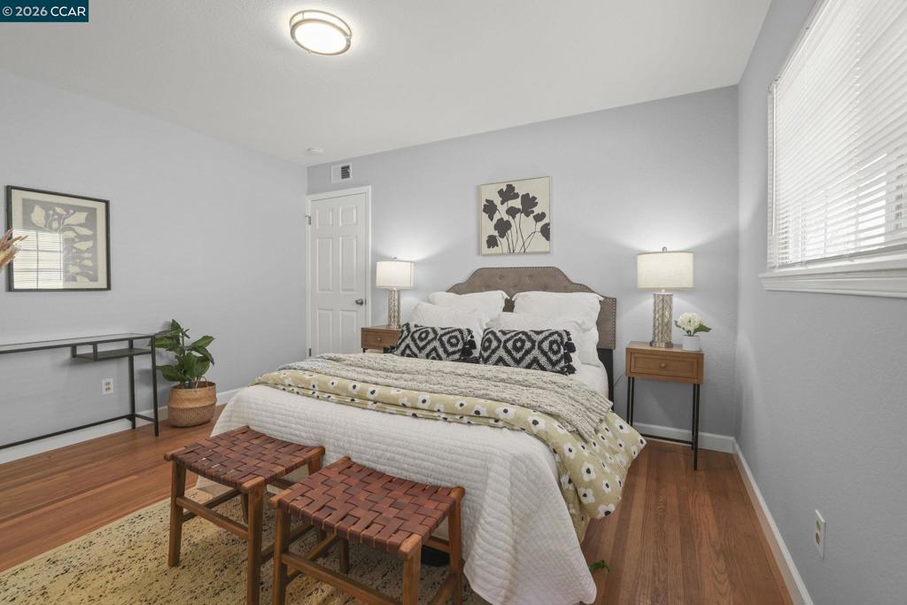 3613-3613 Longview Road Antioch, CA 94509 - Photo 21 of 30 a bedroom with a bed and wooden floor