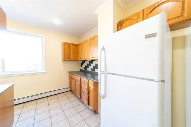 a kitchen with a refrigerator sink stove and cabinets