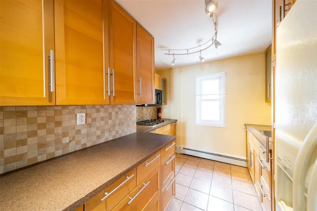 a kitchen with a sink a counter top space and cabinets