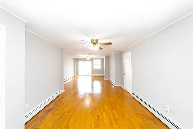 a big room with wooden floor and natural light