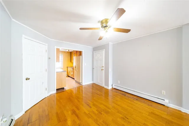 a view of a bedroom with a bed and a chandelier fan