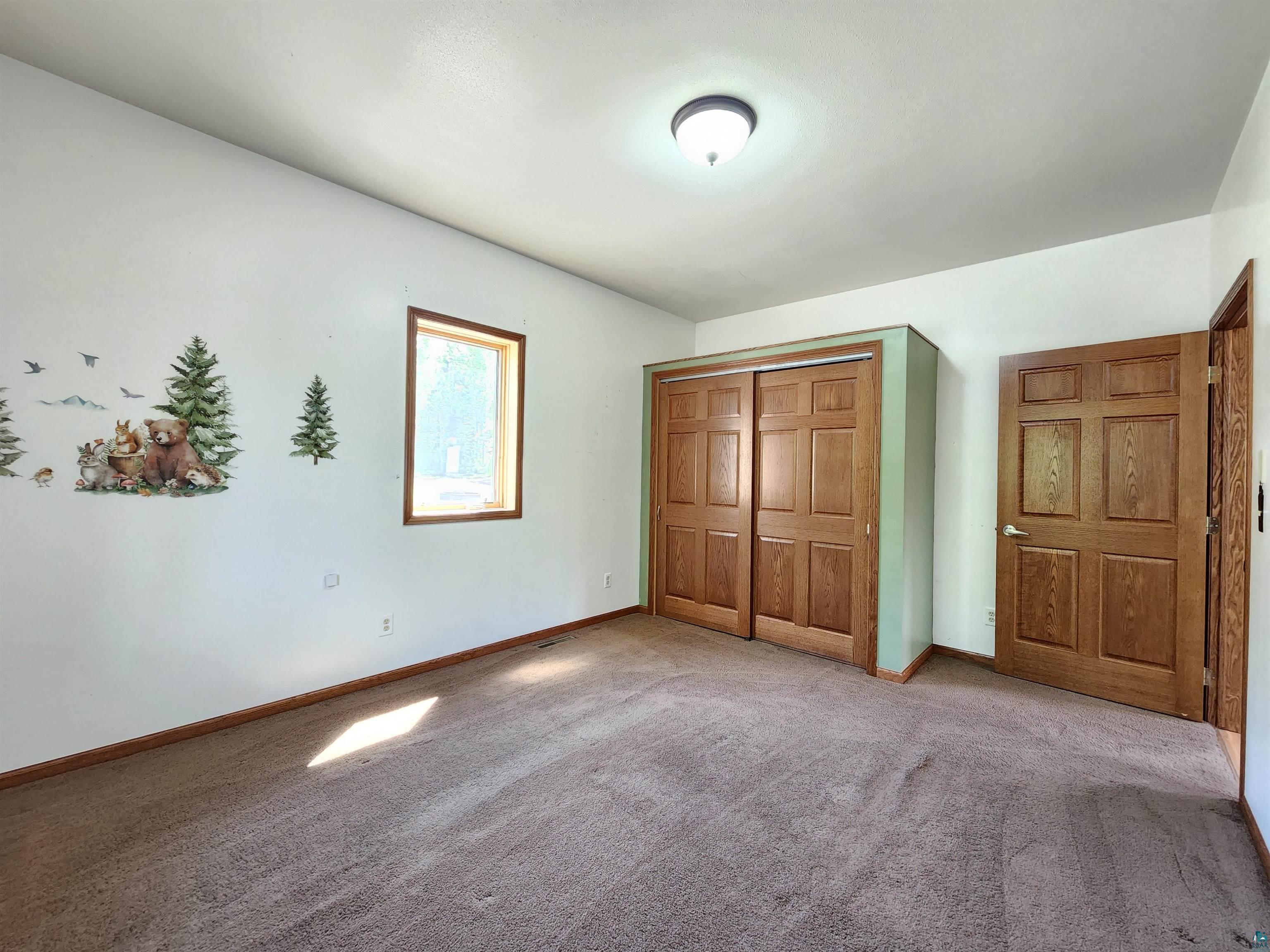 21695 State Highway 13 Cornucopia, WI 54827 - Photo 8 of 33 main floor bedroom
