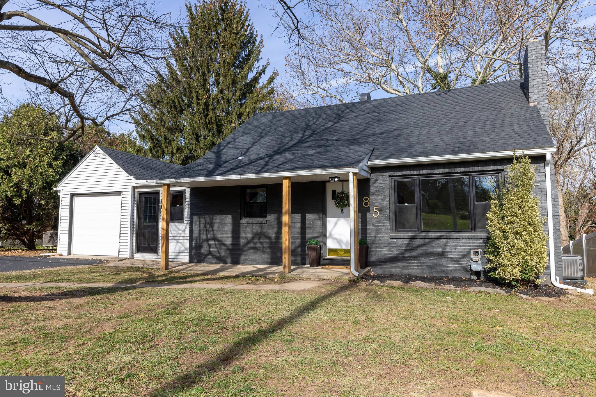 a view of a house with yard and sitting area