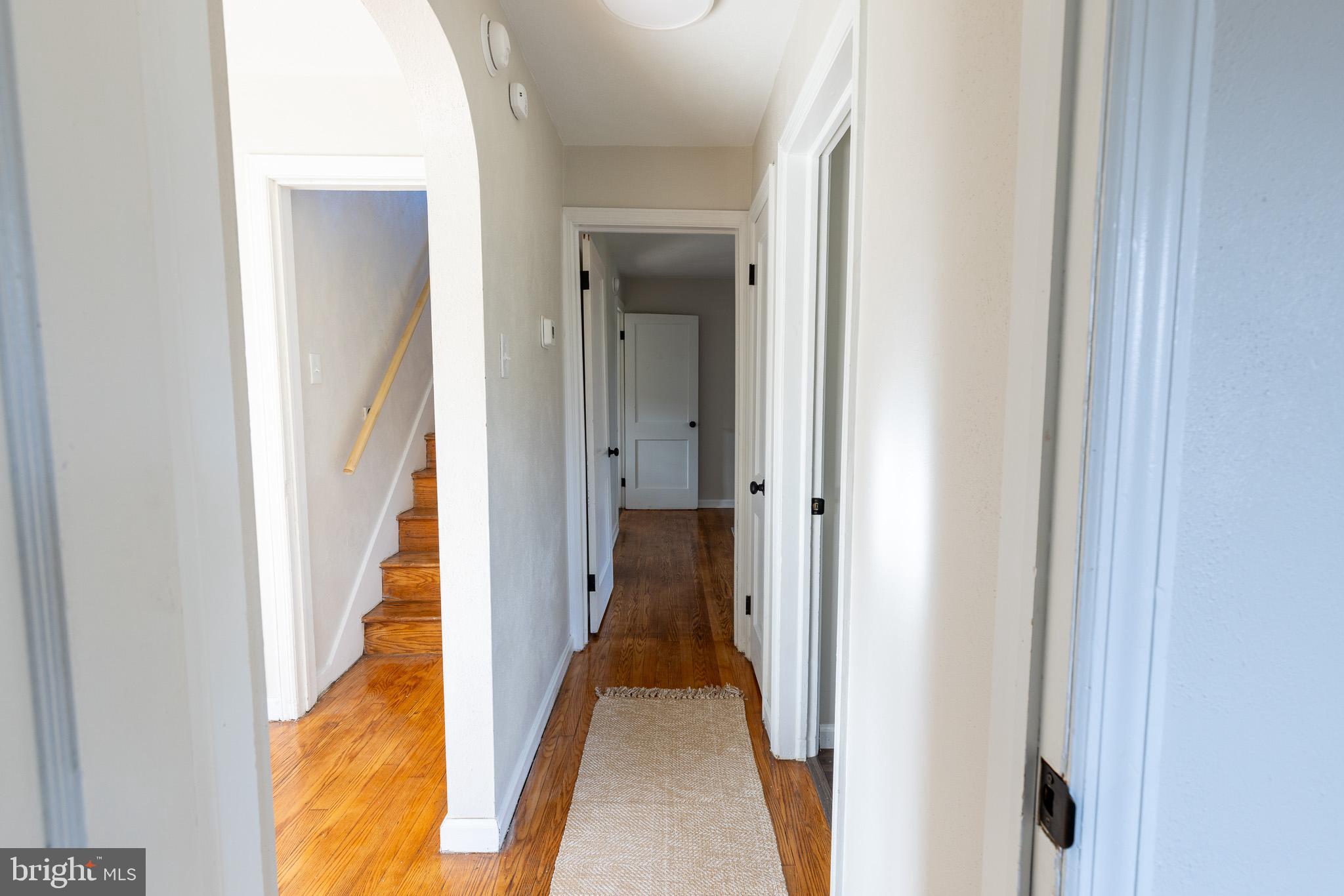85 Homeland Road York, PA 17403 - Photo 14 of 26 a view of a hallway with wooden floor and a bathroom