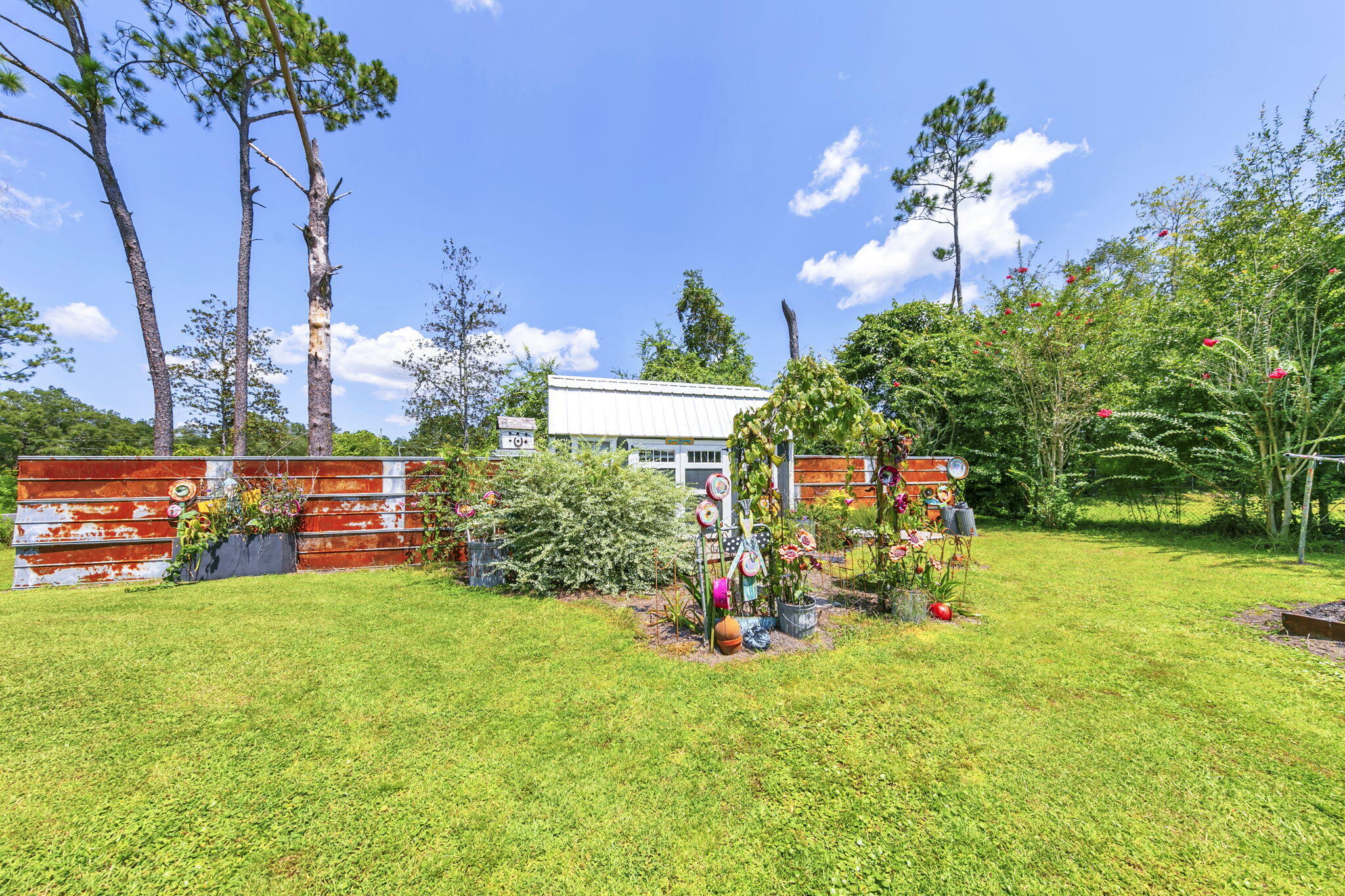 90 Jones Drive Freeport, FL 32439 - Photo 27 of 31 a view of a backyard with plants and large trees