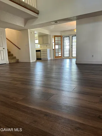 a view of a room with wooden floor