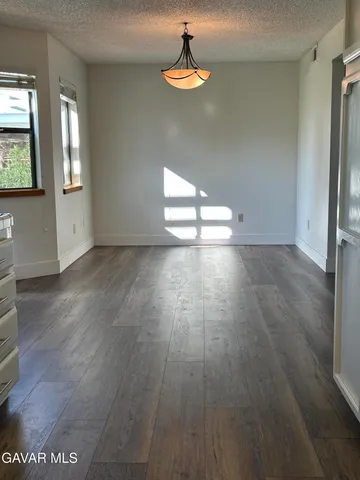 a kitchen with stainless steel appliances a refrigerator and a stove top oven