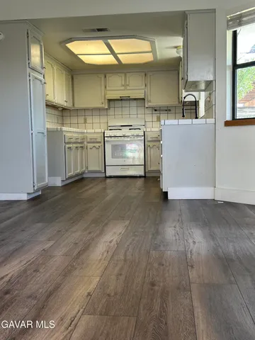 a kitchen with stainless steel appliances a sink and a window
