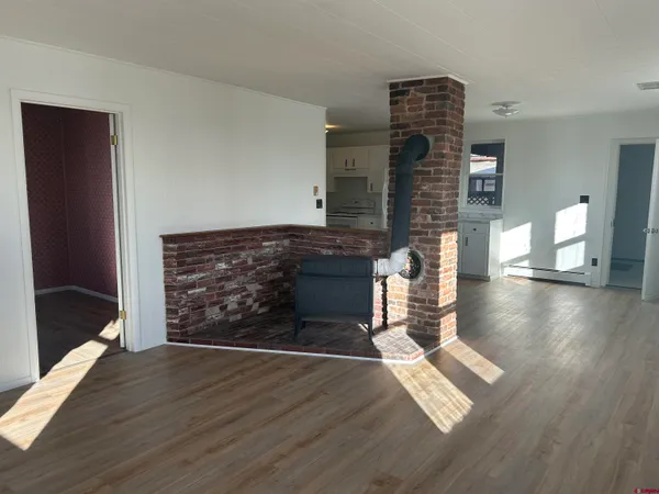 a view of a kitchen with a sink and a refrigerator