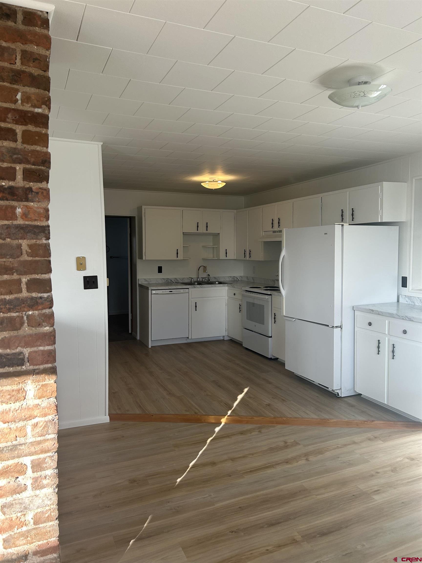 281 Fox Street Nucla, CO 81424 - Photo 9 of 21 a view of a kitchen with a sink and a refrigerator