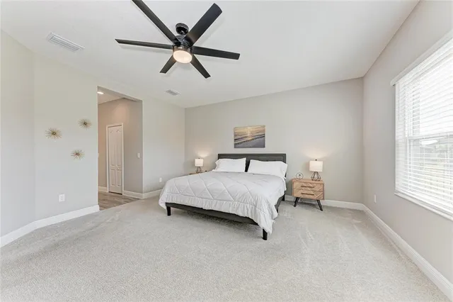 a bedroom with a bed a desk and chair