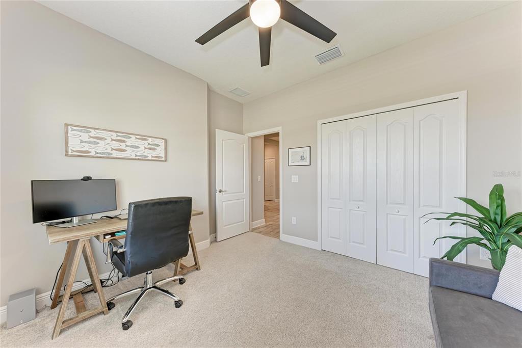 4211 Rustling Pines Terrace Parrish, FL 34219 - Photo 31 of 87 a view of a workspace with furniture and a ceiling fan