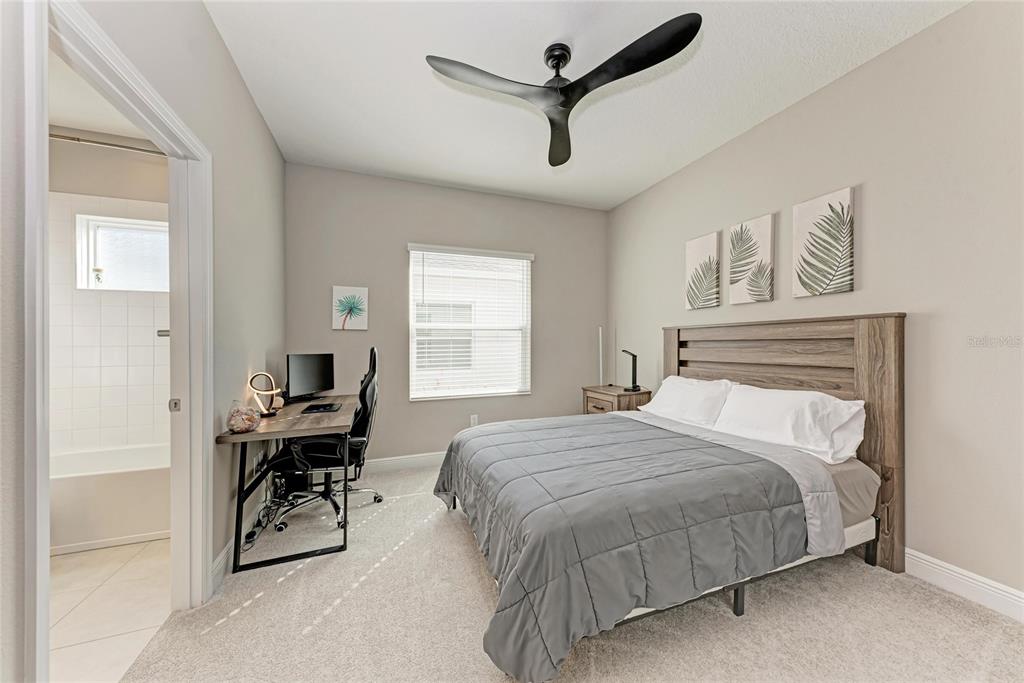 4211 Rustling Pines Terrace Parrish, FL 34219 - Photo 36 of 87 a bedroom with a bed a desk and chair