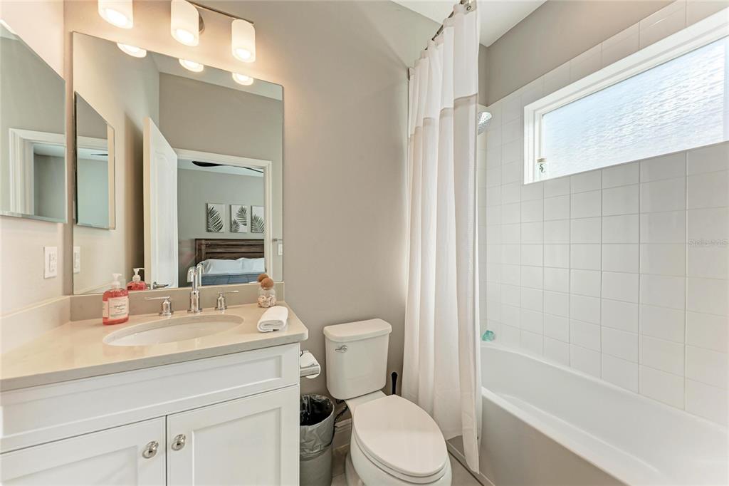 4211 Rustling Pines Terrace Parrish, FL 34219 - Photo 39 of 87 a bathroom with a sink a toilet a mirror and shower