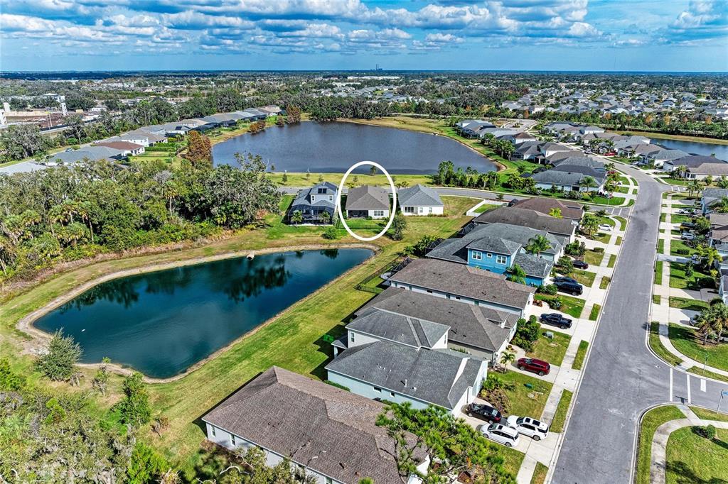 4211 Rustling Pines Terrace Parrish, FL 34219 - Photo 47 of 87 an aerial view of a house with a garden and lake view