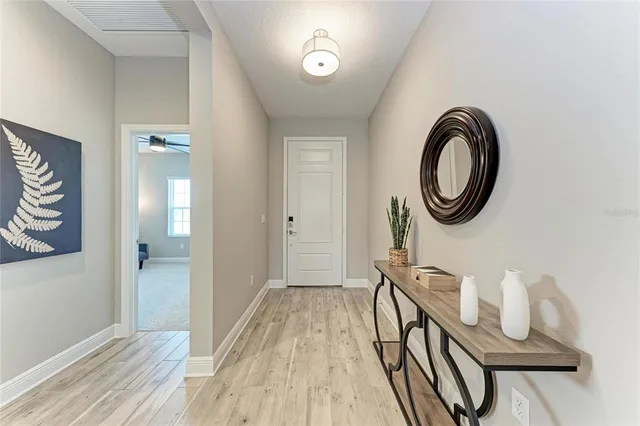 a living room with furniture and a large window with wooden floor