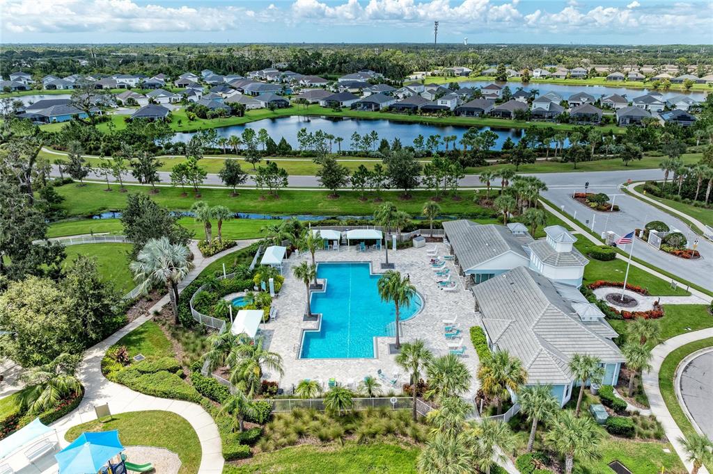 4211 Rustling Pines Terrace Parrish, FL 34219 - Photo 74 of 87 an aerial view of a city with lots of residential buildings ocean and mountain view in back