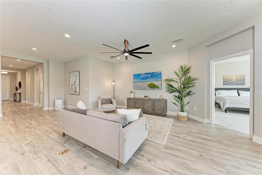 4211 Rustling Pines Terrace Parrish, FL 34219 - Photo 9 of 87 a living room with furniture and a large window with potted plants
