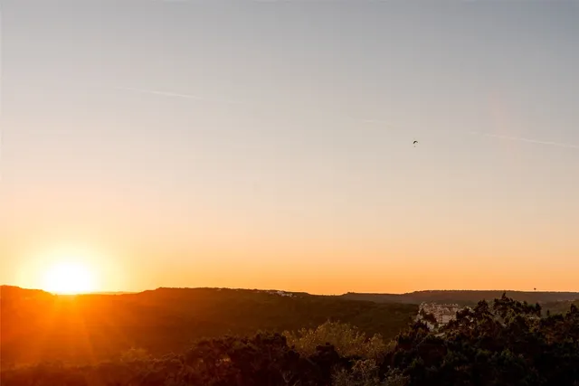 an aerial view of ocean and residential houses with outdoor space