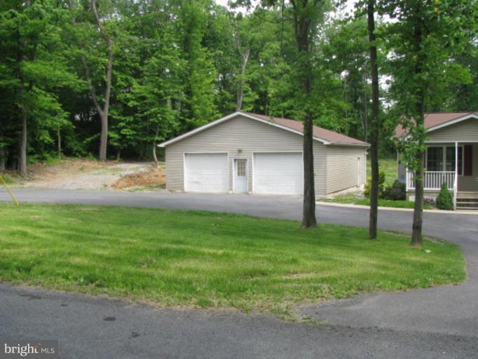 21 Drummer Hill Road Front Royal, VA 22630 - Photo 2 of 11 a backyard of a house with plants and large trees