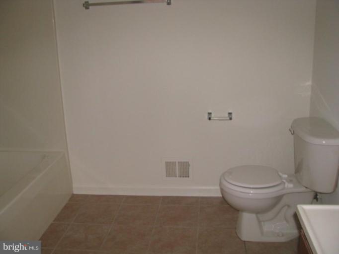 21 Drummer Hill Road Front Royal, VA 22630 - Photo 8 of 11 a white toilet sitting next to a white wall