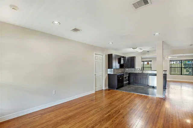 wooden floor in kitchen and a room with wooden floor